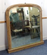 A 19th century stripped pine overmantel mirror - the original arched plate in a moulded frame with