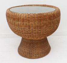 A retro circular wicker conservatory table - 1970s-80s, the inset glass top over a waisted base,