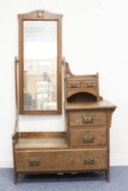 An oak Arts & Crafts style dressing-table in the manner of Liberty - the tall, arched mirror with