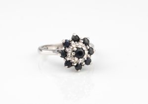 An 18ct white gold, sapphire and diamond cluster ring - hallmarked London 1978, set with a cluster