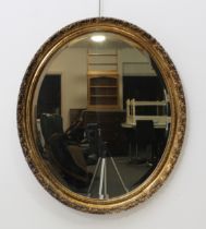 An oval wall mirror with moulded gilt frame (69 x 59.5 cm)