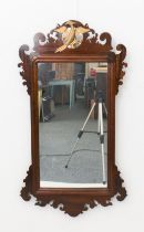 A George II style mahogany and parcel-gilt fret framed mirror - mid-20th century, the rectangular