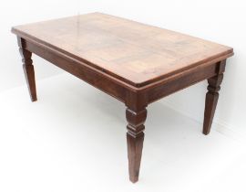 A late 19th century Continental oak dining table - the panelled and cleated top over a deep
