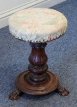 A William IV carved walnut adjustable piano stool - the stuff-over seat on a lappet carved