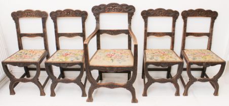 A set of five (4 + 1) mid-19th century carved oak 'Green Man' dining chairs - the scalloped top rail