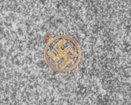 A 9ct rose gold Swastika pendant - probably early 20th century, with foliate chased decoration,