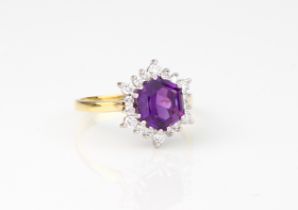 An 18ct yellow gold, amethyst and diamond cluster ring - hallmarked London 2008, the approx. 13.5mm.