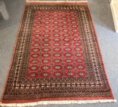 A large Bokhara style wool rug - probably Pakistan, last quarter 20th century, with five rows of