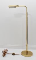 A brass floor-standing adjustable reading lamp - with angular swivel shade and adjustable height, on