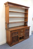 A late 19th century Continental stained pine dresser - the flared, ogee moulded cornice over an open