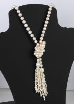 A freshwater pearl lanyard necklace - the long, single strand of approx. 8mm. pearls terminating