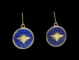 A pair of lapis lazuli earrings - the lapis discs with gold plated frames and  set with a gold