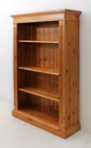 A pine open bookcase by Gillerson Pine - the outset moulded top over four adjustable shelves flanked