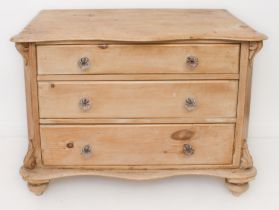 A Victorian waxed pine three-drawer chest - the serpentine, single-piece top on foliate brackets