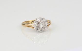 An 18ct yellow gold and diamond daisy cluster ring - stamped '18CT', with a bright cut, floral style