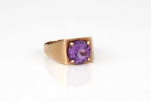 A vintage 9ct yellow gold and amethyst ring - hallmarked Birmingham 1970, the 8mm. round cut