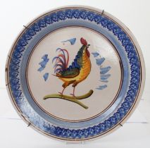 A French faience tin glazed charger - probably early 20th century, painted with a cockerel, within a