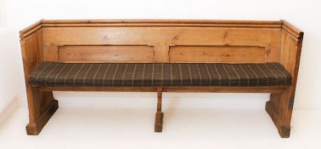 A Victorian pine pew - the chamfer-panelled back with a trefoil shaped handrail above, over a