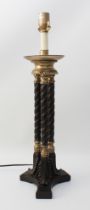 A bronzed and parcel-gilt triple-column lamp in the Regency style - modern, the dished top on