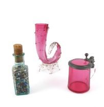 A collection of Victorian beads in a similar period glass bottle, and two cranberry glasses, vase