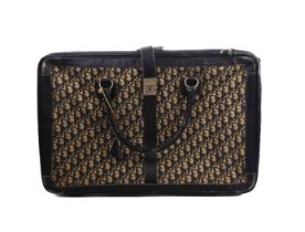 A vintage Christian Dior leather and monogram fabric suitcase - 1980s, in dark blue leather with