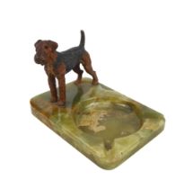 A cold-painted model of an Airedale on a green onyx base, circa 1950.