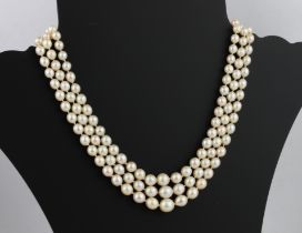 A cultured pearl three-row necklace with 9ct white gold, sapphire and pearl clasp - the clasp