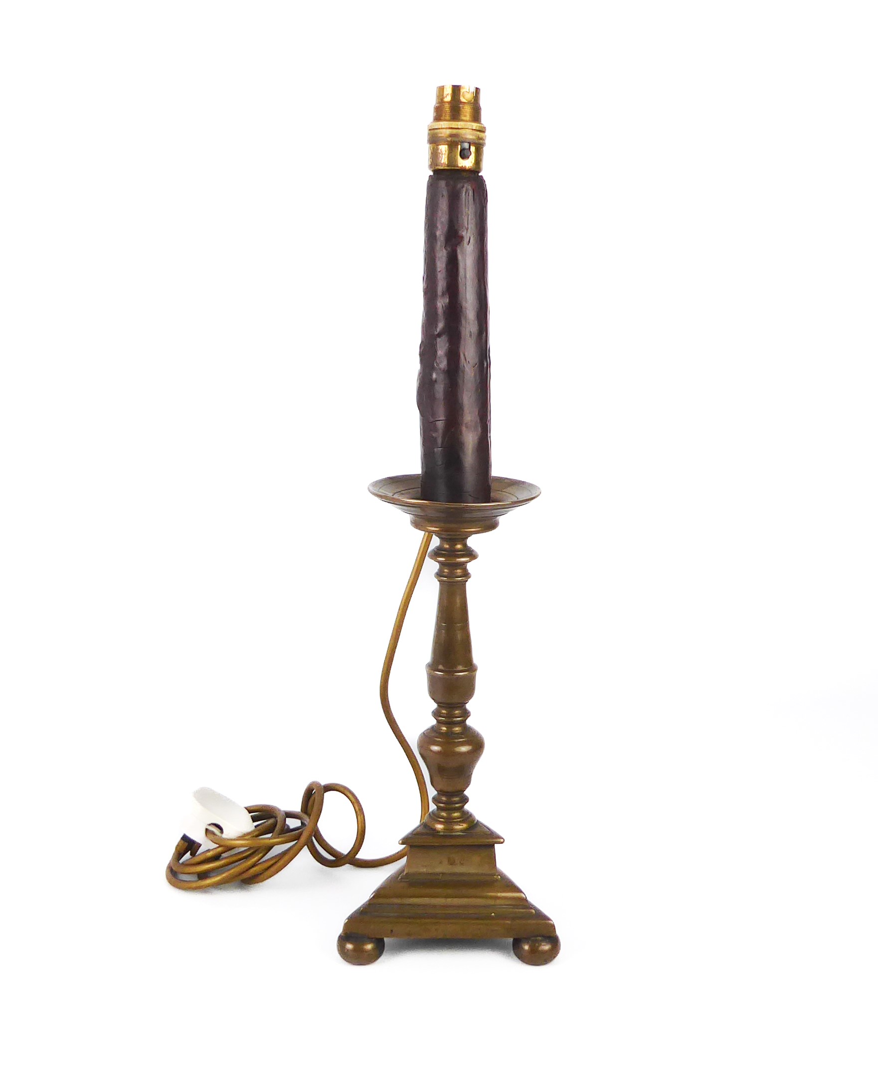A late-18th century brass tripod candlestick adapted as a table lamp, the trainagular base marked
