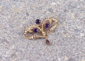 An Edwardian 9ct gold, seed pearl and amethyst brooch - unmarked, tests as 9ct gold, of openwork