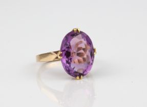 A 9ct gold ring and amethyst ring - stamped '9CT', the large 14.5 x 11mm oval cut amethyst over