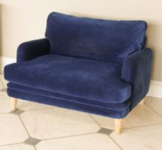 A Loaf Squisheroo love seat - upholstered in Royal blue velvet, raised on turned limed oak feet, 115