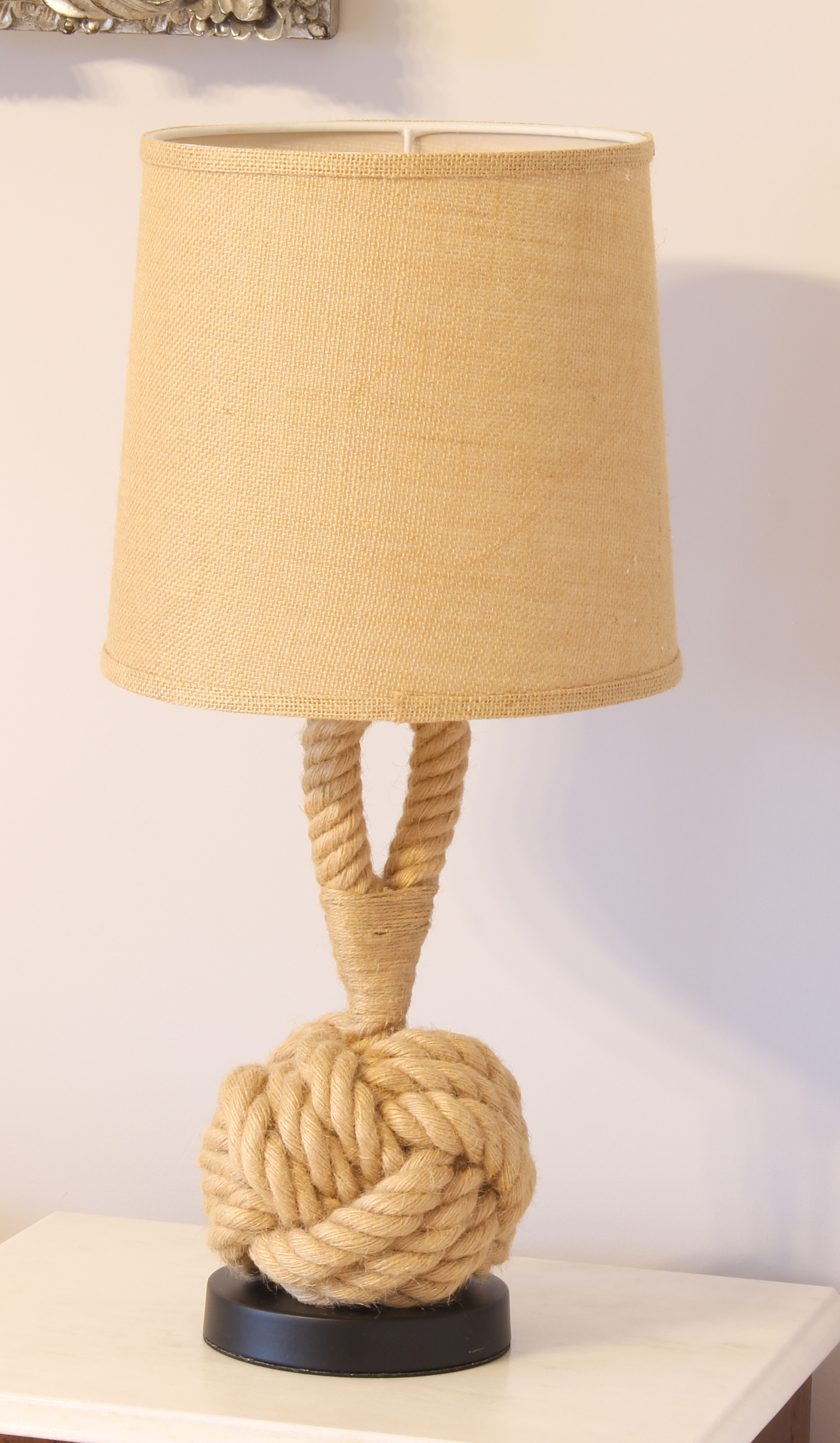 A nautical style knotted rope table lamp - with ebonised base and hessian shade, 58 cm high;