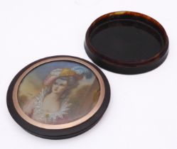 A circular gold and tortoiseshell box with inset miniature
