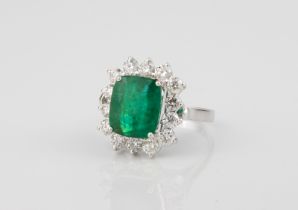 An 18ct white gold, emerald and diamond ring