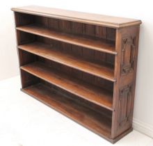 A 19th century oak open bookcase - the moulded top over four graduated open shelves, the sides