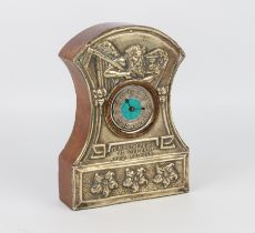 An Arts and Crafts mantle clock; the face silver plated with embossed design of Old Father Time