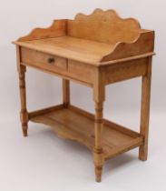 A Victorian waxed pine washstand - with shaped three-quarter gallery, single frieze drawer and pot