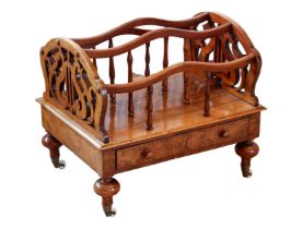 A Victorian walnut Canterbury - with three serpentine divisions on turned supports and fretwork