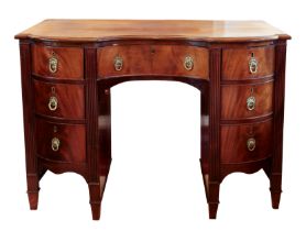 A late 19th century mahogany inverted bowfronted desk in the Georgian style - the moulded top over a