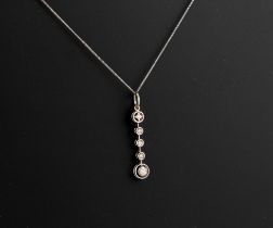 An Edwardian style 9ct white gold and diamond five stone drop pendant - with two halo set