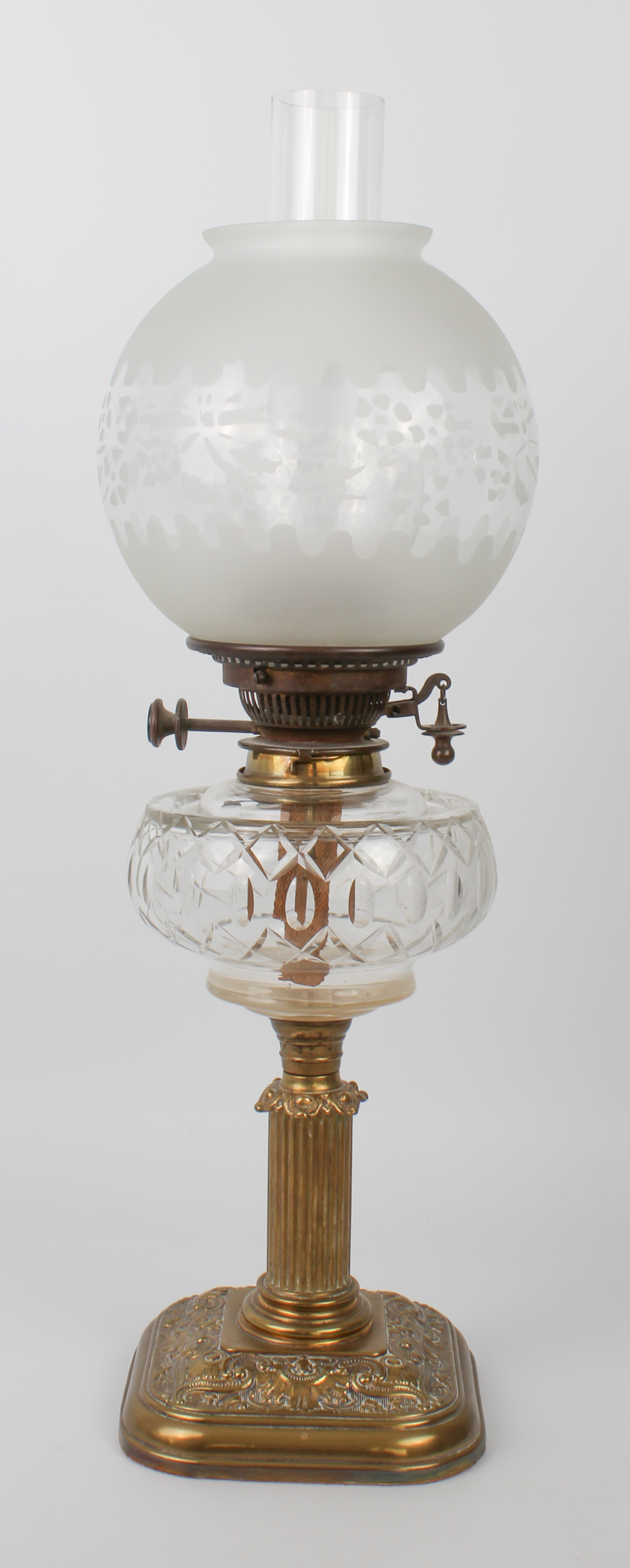 An Edwardian brass and cut glass oil lamp by Hinks & Sons for Maple of London, the rounded square