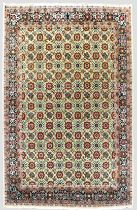 A large north-west Persian Varamin wool rug - the ivory field with all over polychrome floral