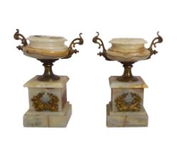 A pair of gilt metal and onyx urns - early 20th century, with foliate gilt metal twin handles and