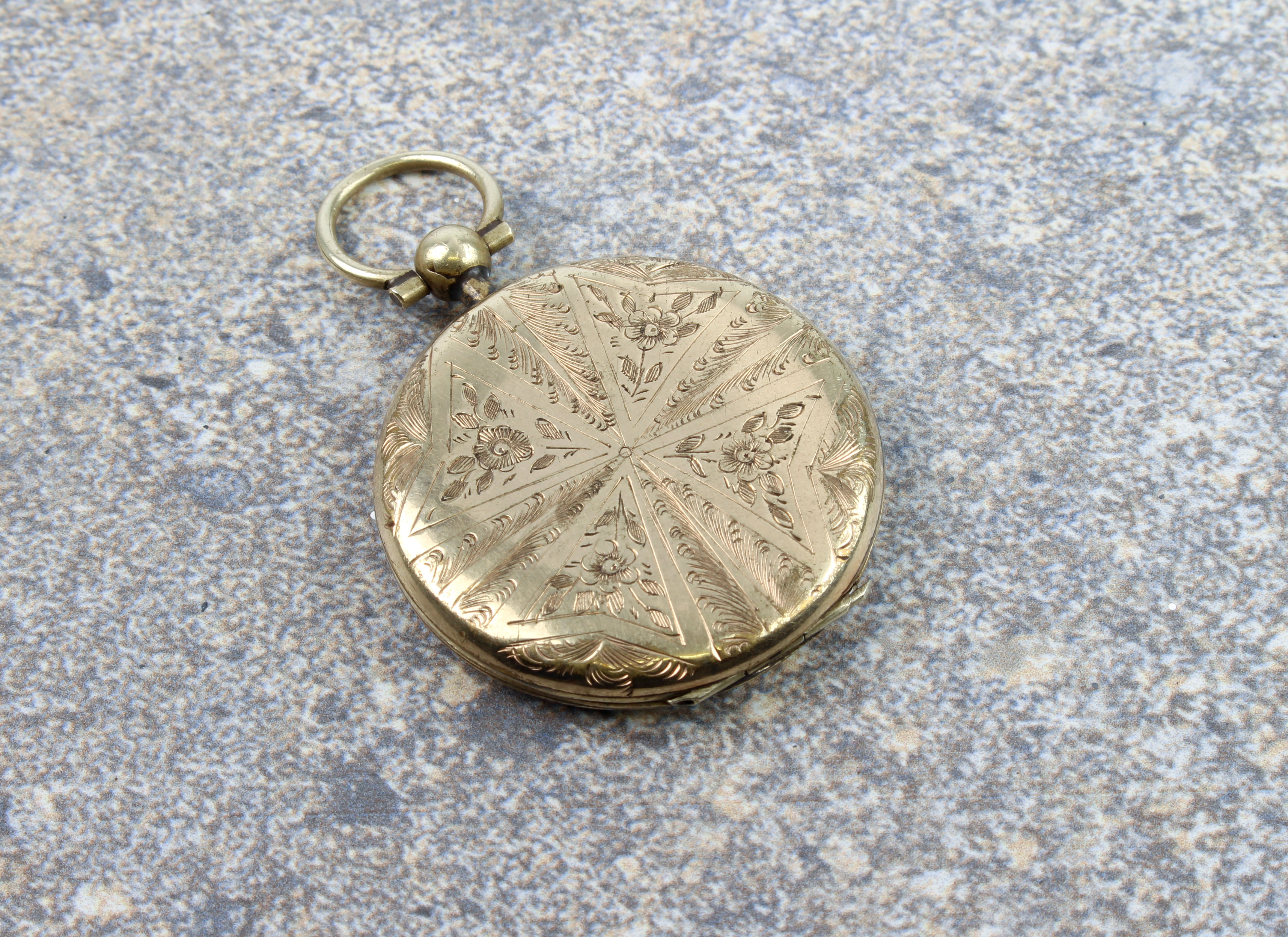 A late Victorian rolled gold locket - circular, chased with flowers and foliage in a radial pattern, - Image 2 of 3