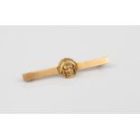 A Native Indian mask bar-brooch (stamped 4K, tests as 14ct gold) - 45mm long.