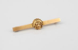 A Native Indian mask bar-brooch (stamped 4K, tests as 14ct gold) - 45mm long.