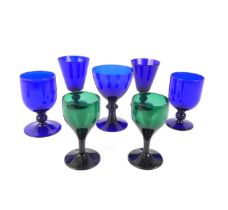 Five modern Bristol-blue goblets or rummers and a pair of Bristol-green glass wines, tallest 14 cm