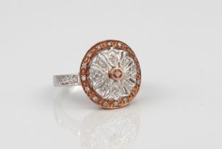 A 9ct white and rose gold and diamond floral cluster ring - the pierced halo style floral cluster