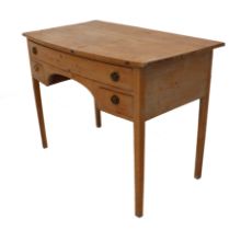 An early 19th century pine bowfront kneehole dressing table - with one long and two short drawers