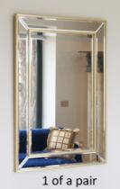 A pair of bevelled parcel-gilt mirrors - modern, rectangular with gilt edge-frame and slip, 95 x